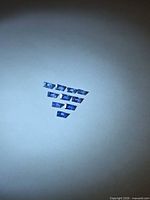 Ten baguette-cut blue sapphires arranged in a triangle