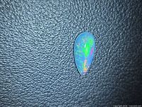 Front view of pear cabochon opal showing multicolor play-of-color