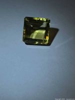 Angled view of square lemon citrine on white background