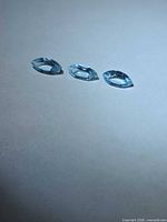 Three sky blue marquise topaz stones viewed from oblique angle
