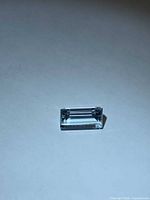 Front view of rectangular baguette-cut aquamarine on neutral background