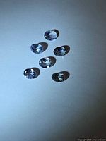 Six oval tanzanite gemstones viewed from above
