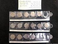 Full view of 15 George VI nickels in sleeves with handwritten year labels