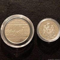 Both coins obverse sides in capsules