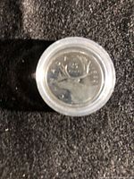 Encapsulated 1982 Canadian quarter, angled view