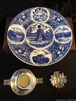 Top-down view showing all three items: plate, pewter bowl, teabag dish