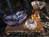 Cobalt blue cut-to-clear bowl, amber vase, clear/ruby paperweight on stand