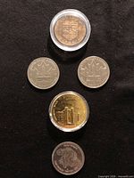 Group of all five commemorative coins arranged for overview