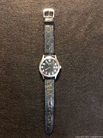 Full view of watch front showing dial and strap