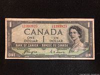 Front of 1954 Canada $1 note showing serial DA1393825, Queen Elizabeth II portrait, signatures