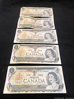 Obverse of five 1973 Canadian $1 notes