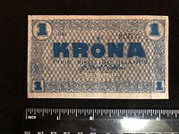 Front of 1941 Iceland 1 krona banknote with ruler for scale