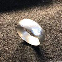 Domed sterling silver band ring angled view