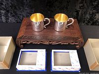 Pair of silverplate baby cups on wooden stand with original boxes