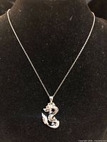 Dragon pendant necklace displayed on bust