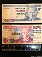Both banknotes with ruler for scale