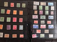 Two album stock pages showing 45 unused Newfoundland stamps in various colours and denominations