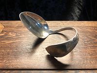 Side view showing full spoon shape and open cuff form