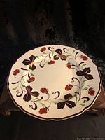 Front view of plate showing full hand-painted strawberry design