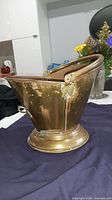Full view of copper/brass coal scuttle showing overall shape, pedestal base, top handle
