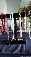 Full view of all necklaces and earrings on jewellery stand