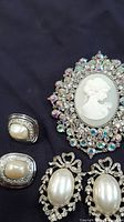 Cameo brooch, square faux pearl earrings pair, oval faux pearl earrings pair