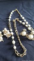 Necklace with faux pearls and both earring sets overview
