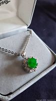 Necklace in box showing jadeite pendant and chain
