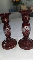 Front view showing both ruby glass candlesticks