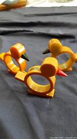 Three Bakelite bird napkin rings grouped