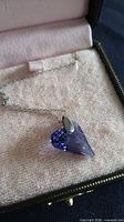 Necklace in box showing chain and heart pendant