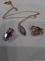 Necklace and both earrings showing crystal color and settings