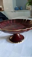 Full view of red Carlton Ware pedestal bowl on table