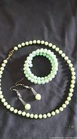 Entire set laid out: necklace, bracelet, earrings