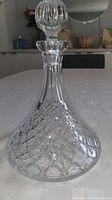 Full view of clear crystal ship's decanter with stopper inserted
