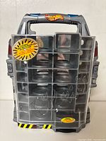 Front view of Hot Wheels micro display case showing clear compartment cover, handle, and decals