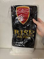 Full packaged scarf showing Budweiser crest and "RISE AS ONE" text