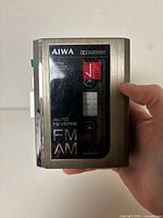 Front view showing Aiwa branding, HS-J706 model marking, auto reverse and FM/AM indications