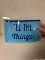 Front view of sealed blue pouch showing text and zipper