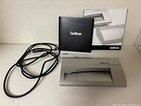 Scanner, cable, manual and box displayed together