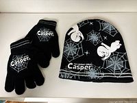Hat and gloves laid out flat showing graphics