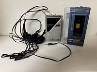 Front view of both cassette players with headsets showing overall condition