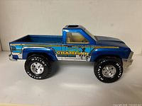 Full left side view of blue Nylint Champion Quarter Horse truck