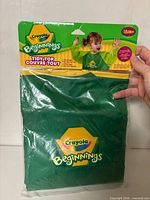 Front view of sealed package showing smock color, logo, size info