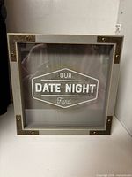 Front view showing "Our Date Night Fund" text and brass-tone corners