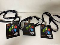 Three Inside Out promo passes each attached to black lanyards laid out