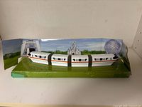 Full view of metal monorail on cardboard backdrop