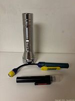 Front view of all three flashlights showing size and branding