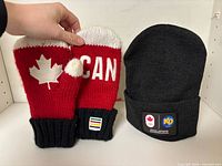 Mittens and toque front view showing designs and logos
