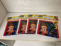 Four sealed packs of Jimmy Neutron gift bags laid out